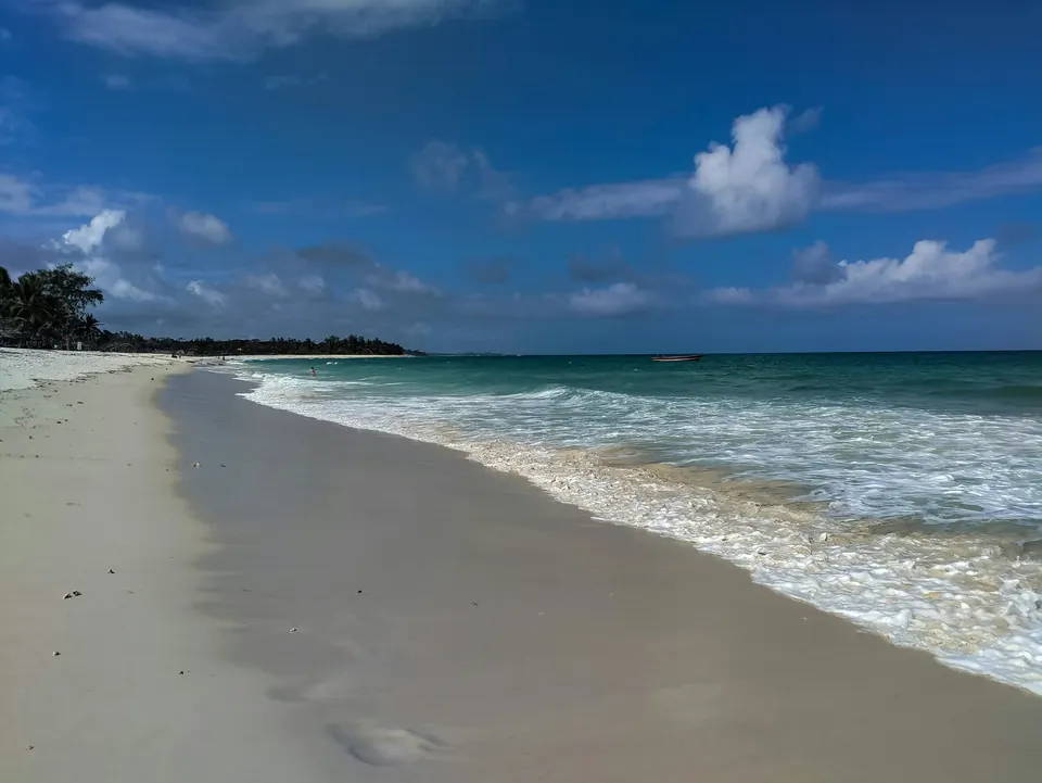 Waves running up a long white-sand beach at Diani, on Kenya’s south coast.