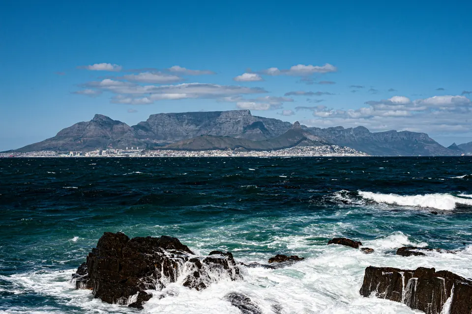 Table Mountain and Cape Town across Table Bay, seen from the rocky shore of Robben Island.